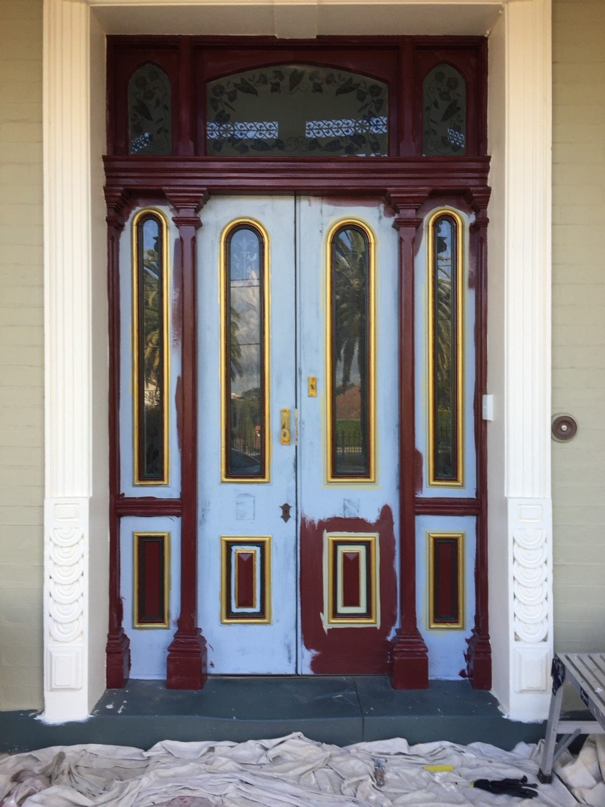 A heritage front door part-way through being stripped back and repainted