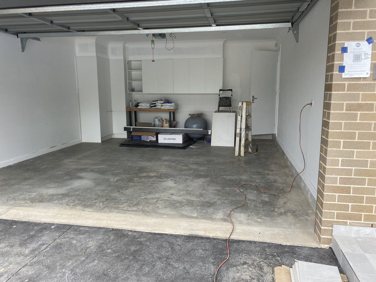 The same garage before, with a bare, unsealed concrete floor
